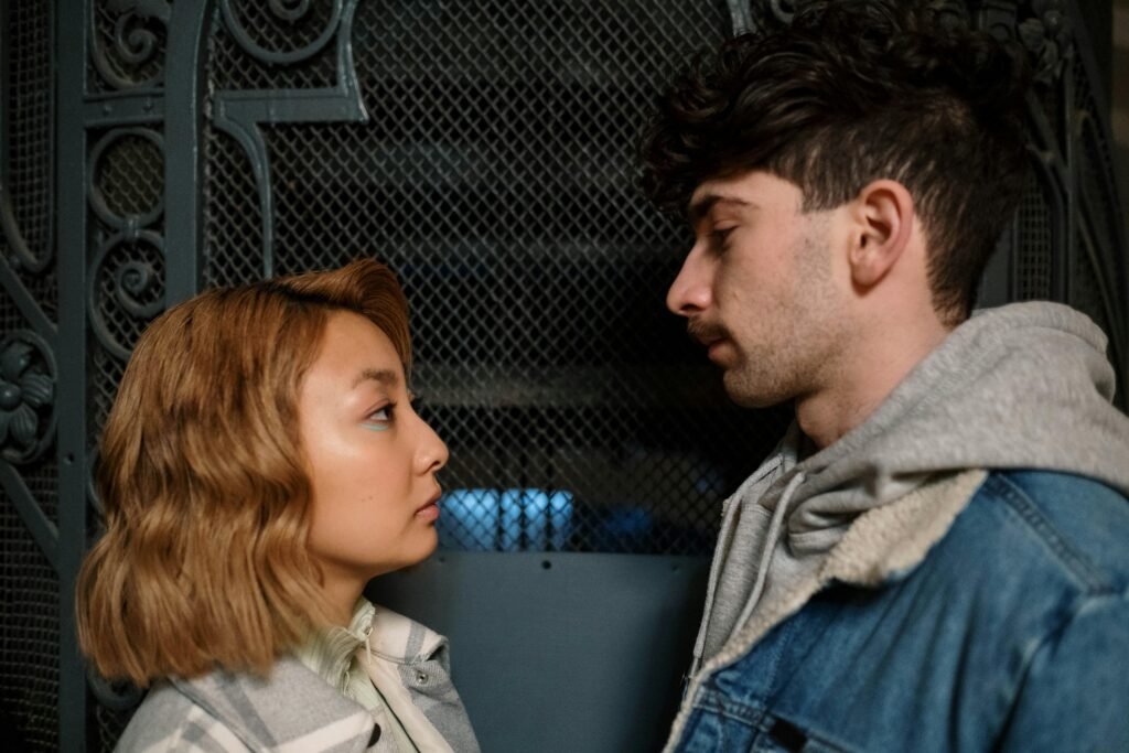 The Tinder Alternative for Hookup that Works without Facebook 3 A young couple looking at each other intently, conveying romantic connection indoors.